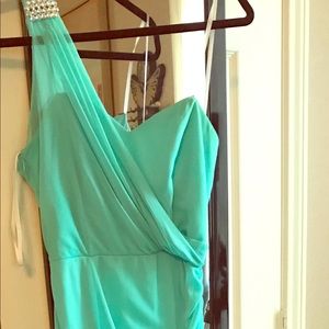 Long teal color dress.